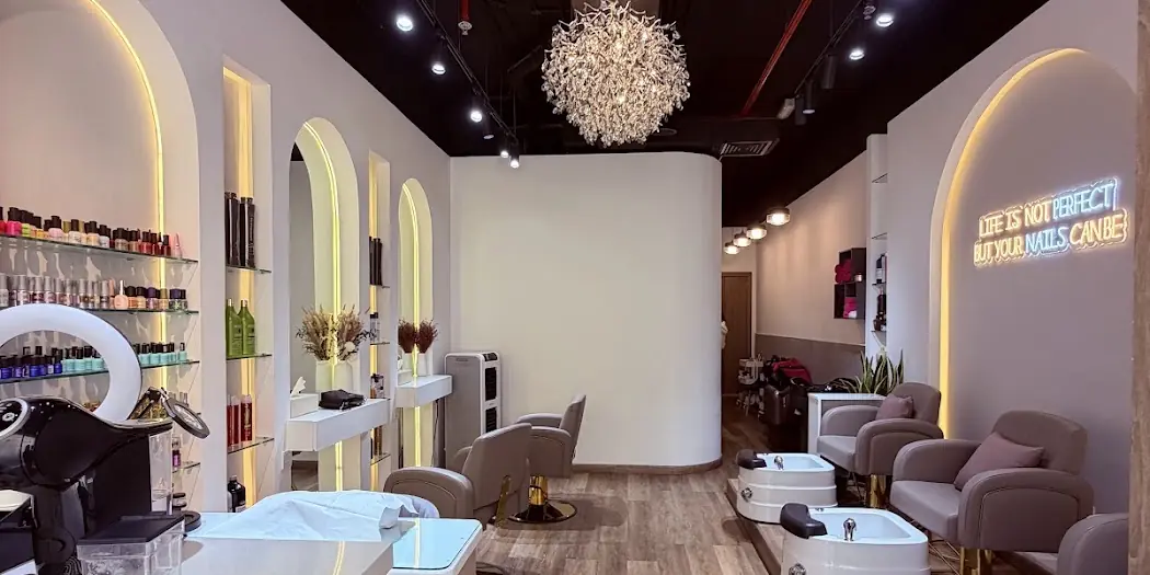 The Ash Beauty nail bar with lit arches, polish wall and chandelier