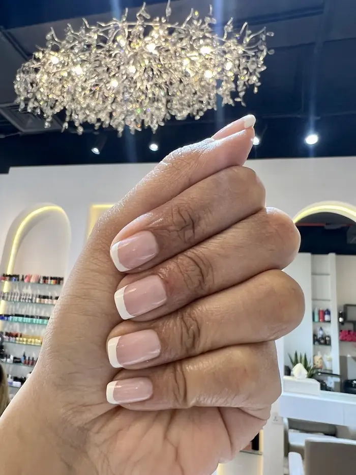 Natural French manicure under the Ash Beauty chandelier
